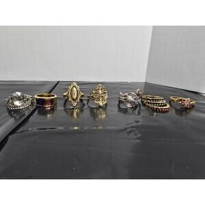 Mixed 9 Costume Rings Silver and Gold Tone With Stones showing size 10.5 on